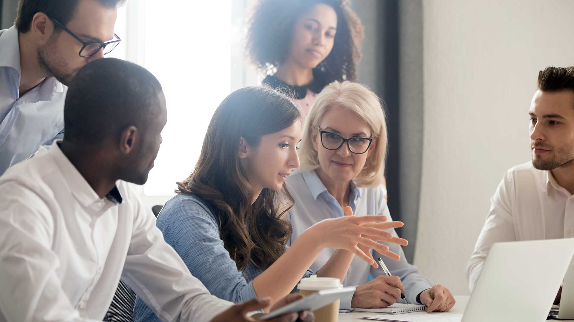 Photo of a diverse group of researchers discussing their work.